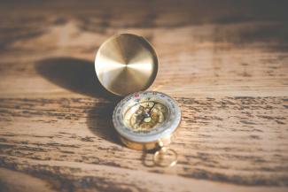 Compass on wood table.