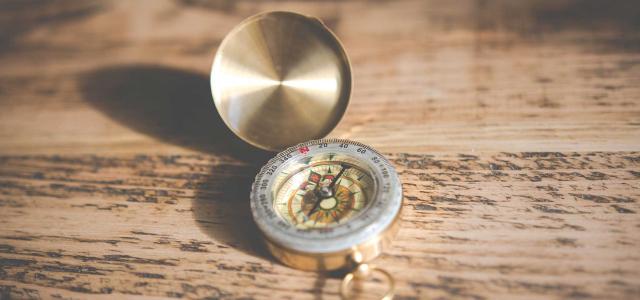 Compass on wood table.